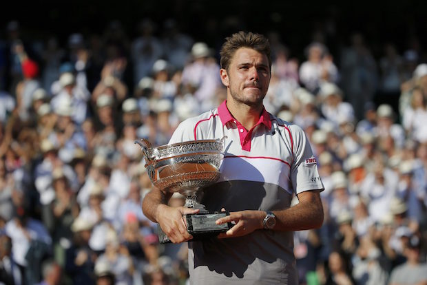 Stan Wawrinka of Switzerland poses with the trophy during the ceremony after winning the men's singles final match against Novak Djokovic of Serbia at the French Open tennis tournament at the Roland Garros stadium in Paris
