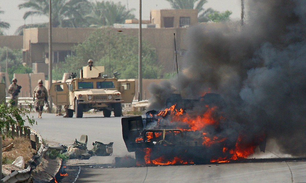 US Army soldiers respond to a roadside bomb that targeted an American convoy on the highway leading to the airport, in Baghdad, Iraq, Friday, May 13, 2005. A roadside bomb completely destroyed one humvee. (AP Photo/Hadi Mizban)